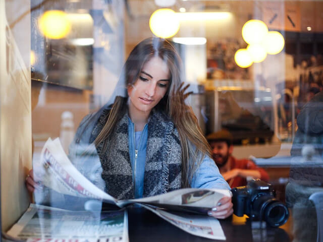 girl reading newspaper